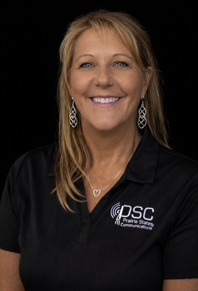 Smiling woman in black PSC shirt.