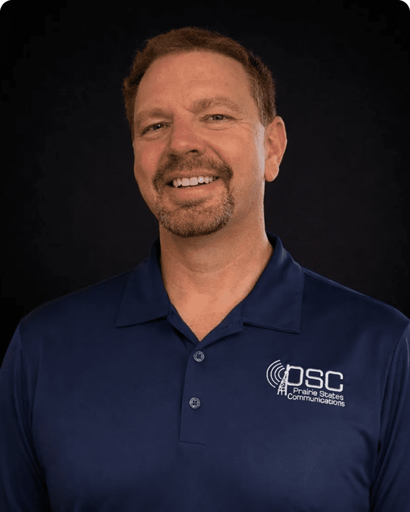 Smiling man in blue PSC shirt.
