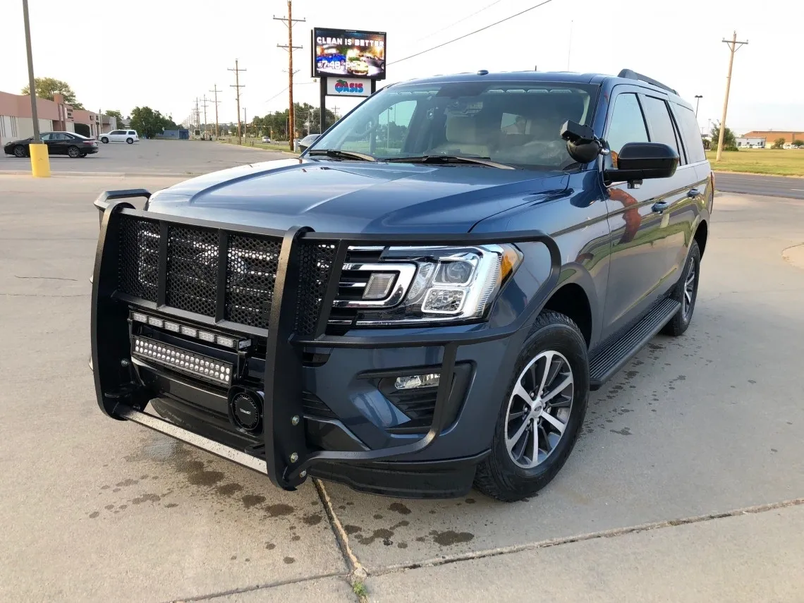 Blue SUV with front bull bar parked.